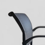 Load image into Gallery viewer, Side view of KI Rapture arm chair showing a detailed view of integrated chair grip in the backrest
