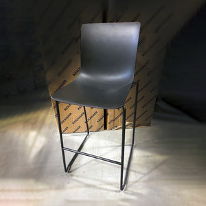 Front view of Keilhauer Epix bar stool with a dark grey plastic shell, matte black frame and sled base