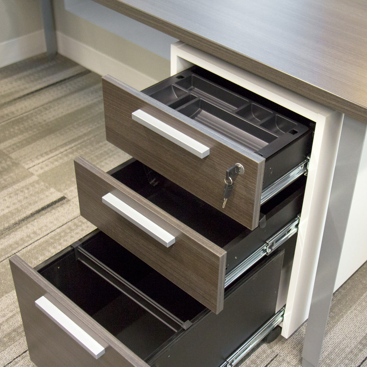 Teknion mobile file pedestal comes with lock, pencil tray and hanging file bar.