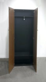 Load image into Gallery viewer, Open view of freestanding Teknion wardrobe shown in rich walnut grain doors and black cabinet with black rectangular door pulls
