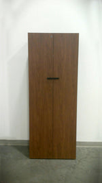 Load image into Gallery viewer, Freestanding Teknion wardrobe in rich walnut grain with black rectangular door pulls
